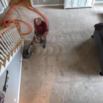 Professional carpet cleaner cleaning living room carpet